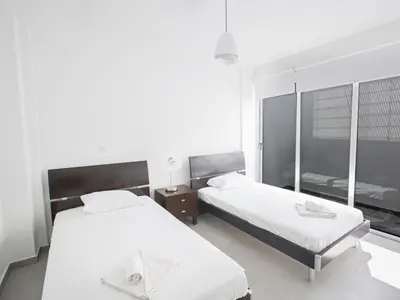 a bedroom with two beds and a window at Holiday Home Wunderschöne- geräumige Ferienvilla mit BBQ by Interhome in Protaras