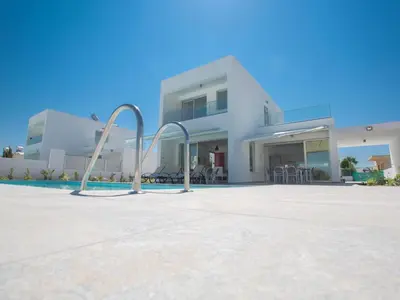 a large white house with a swimming pool at Holiday Home Wunderschöne- geräumige Ferienvilla mit BBQ by Interhome in Protaras