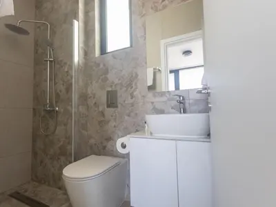 a bathroom with a toilet and a sink and a shower at Holiday Home Protaras Aqua Pearl Villa AQ05 by Interhome in Protaras