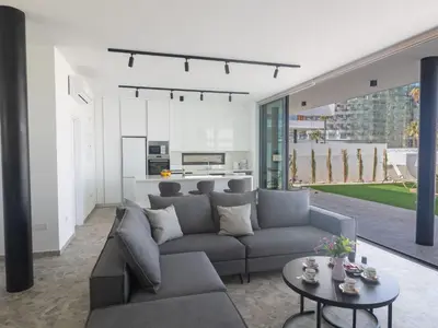 a living room with a couch and a table at Holiday Home Protaras Aqua Pearl Villa AQ05 by Interhome in Protaras