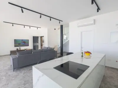 a white living room with a couch and a table at Holiday Home Protaras Aqua Pearl Villa AQ05 by Interhome in Protaras