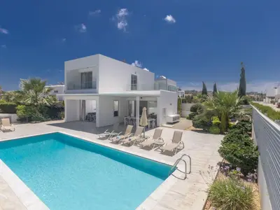 a villa with a swimming pool in front of a house at Holiday Home Greco Villa CCV4- 5-Schlafzimmer-Villa mit privatem Pool in Protaras Zentrum by Interhome in Protaras