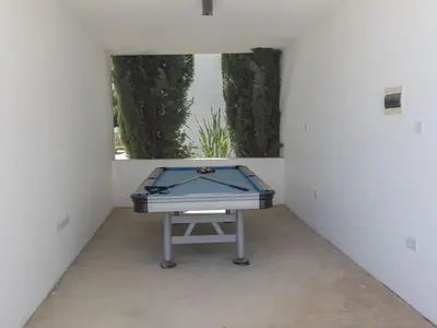 a ping pong table in a room with a window at Holiday Home Greco Villa CCV4- 5-Schlafzimmer-Villa mit privatem Pool in Protaras Zentrum by Interhome in Protaras