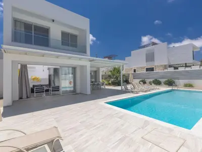 a villa with a swimming pool and a house at Holiday Home Greco Villa CCV4- 5-Schlafzimmer-Villa mit privatem Pool in Protaras Zentrum by Interhome in Protaras