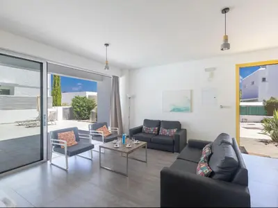 a living room with a couch and a table at Holiday Home Greco Villa CCV4- 5-Schlafzimmer-Villa mit privatem Pool in Protaras Zentrum by Interhome in Protaras