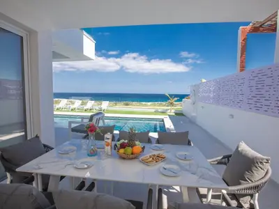 a dining room with a table and a view of the ocean at Holiday Home Eleganter Urlaub Artizan Villa AR5 by Interhome in Protaras