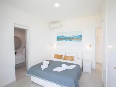 a white bedroom with a bed with towels on it at Holiday Home Eleganter Urlaub Artizan Villa AR5 by Interhome in Protaras