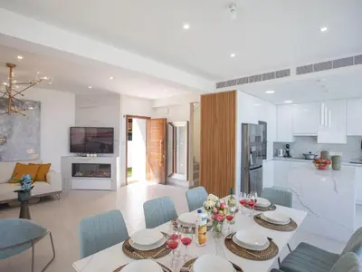a living room with a dining table and a kitchen at Holiday Home Eleganter Urlaub Artizan Villa AR5 by Interhome in Protaras