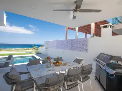 a dining room with a table and chairs and a pool at Holiday Home Eleganter Urlaub Artizan Villa AR5 by Interhome in Protaras