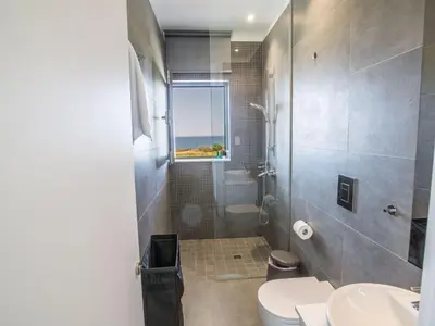 a bathroom with a shower and a toilet and a window at Holiday Home Haus in Paralimni mit großem Patio by Interhome in Paralimni