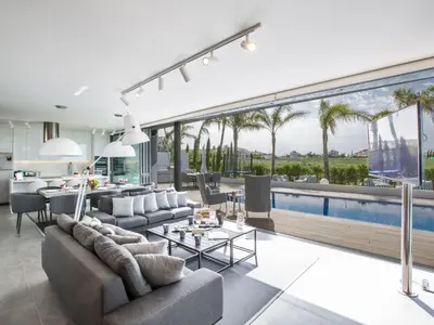 an open living room with a pool and a dining room at Holiday Home Haus in Paralimni mit großem Patio by Interhome in Paralimni