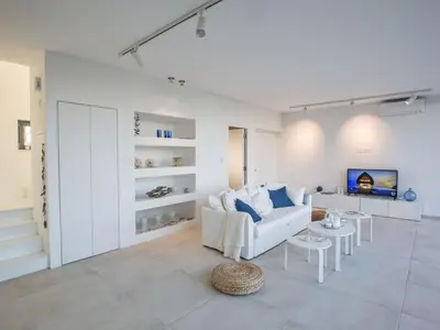 a living room with a white couch and a table at Holiday Home Neue- moderne 3-Schlafzimmer-Villa mit privatem Pool by Interhome in Paralimni