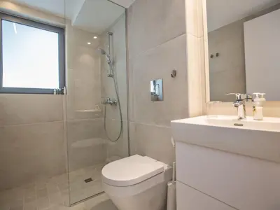a bathroom with a shower and a toilet and a sink at Holiday Home Neue- moderne 3-Schlafzimmer-Villa mit privatem Pool by Interhome in Paralimni