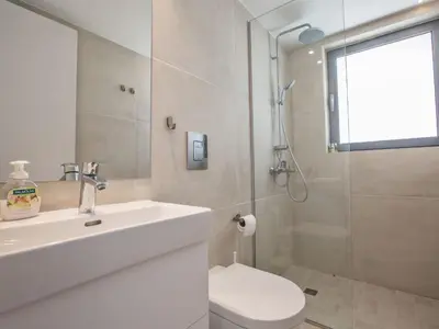 a bathroom with a sink and a toilet and a shower at Holiday Home Neue- moderne 3-Schlafzimmer-Villa mit privatem Pool by Interhome in Paralimni