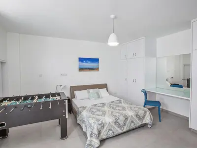 a bedroom with a bed and a desk in it at Holiday Home Protaras Greco Villa CCV1 mit beheiztem Pool by Interhome in Protaras