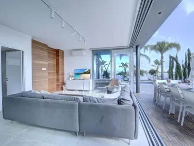 a living room with a couch and a table and chairs at Holiday Home Protaras Ferienvilla mit privatem Pool- Whirlpool by Interhome in Paralimni