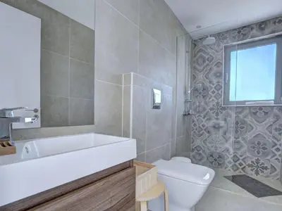 a bathroom with a tub and a toilet and a sink at Holiday Home Protaras Ferienvilla mit privatem Pool- Whirlpool by Interhome in Paralimni
