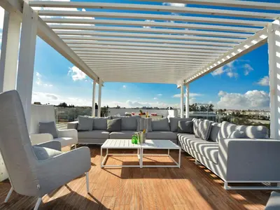 a living room with couches and a table at Holiday Home Protaras Ferienvilla mit privatem Pool- Whirlpool by Interhome in Paralimni