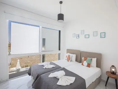 a bedroom with two beds and a large window at Holiday Home Protaras Vie Bleu Villa VB5 by Interhome in Protaras