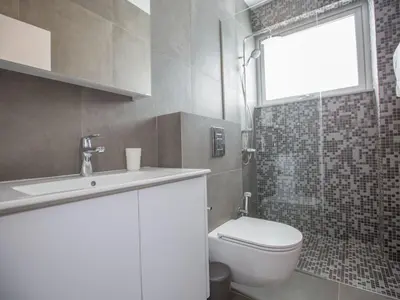 a bathroom with a toilet and a sink and a shower at Holiday Home Ferienvilla Olivine Pearl mit Meerblick by Interhome in Protaras