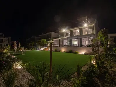 a house with a lawn in front of it at night at Holiday Home Ferienvilla Olivine Pearl mit Meerblick by Interhome in Protaras