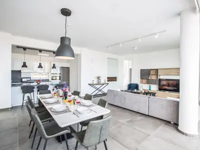 a dining room and kitchen with a table and chairs at Holiday Home Ferienvilla Olivine Pearl mit Meerblick by Interhome in Protaras