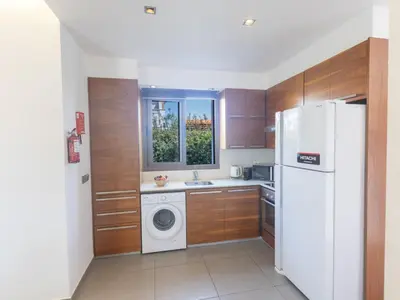a kitchen with a white refrigerator and a washing machine at Holiday Home Ayia Napa Satin Villa SVI1 by Interhome in Ayia Napa