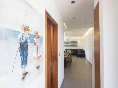 a hallway with a painting of two people on skis at Holiday Home Ayia Napa Satin Villa SVI1 by Interhome in Ayia Napa