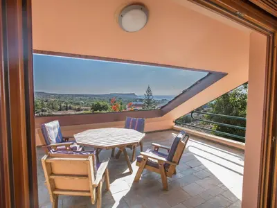 a patio with a table and chairs on a balcony at Holiday Home Private Villa mit Panoramablick auf das Meer by Interhome in Protaras
