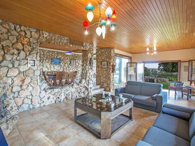 a living room with a stone wall at Holiday Home Private Villa mit Panoramablick auf das Meer by Interhome in Protaras