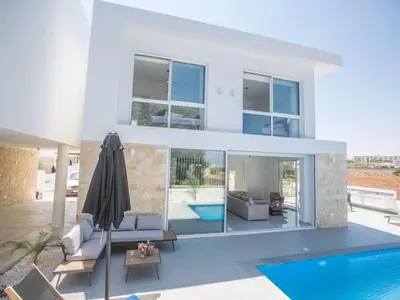 a villa with a swimming pool and a house at Holiday Home 4-Schlafzimmer-Villa mit Pool im Zentrum von Protaras by Interhome in Protaras