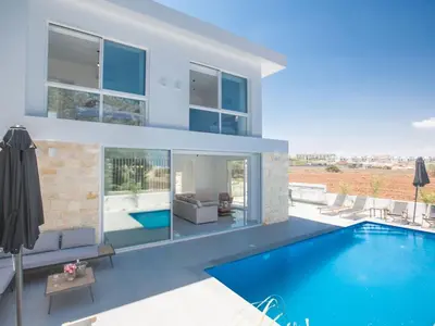 a house with a swimming pool and a patio at Holiday Home 4-Schlafzimmer-Villa mit Pool im Zentrum von Protaras by Interhome in Protaras