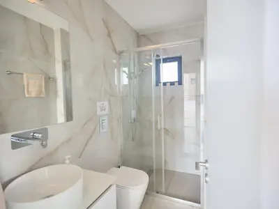 a bathroom with a shower and a toilet and a sink at Holiday Home Protaras Aqua Pearl Villa AQ11 im Zentrum by Interhome in Protaras