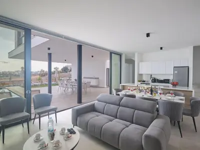 a living room with a couch and a table and a kitchen at Holiday Home Protaras Aqua Pearl Villa AQ11 im Zentrum by Interhome in Protaras