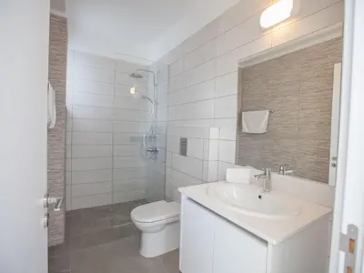 a white bathroom with a toilet and a sink at Holiday Home Schöne Villa Olivine Pearl OL5 mit Garten by Interhome in Protaras