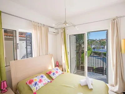a bedroom with a bed and a balcony at Holiday Home Charmante 3-Schlafzimmer-Villa DI12 mit privatem Pool by Interhome in Protaras