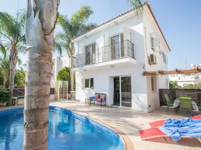 a villa with a swimming pool and a house at Holiday Home Charmante 3-Schlafzimmer-Villa DI12 mit privatem Pool by Interhome in Protaras
