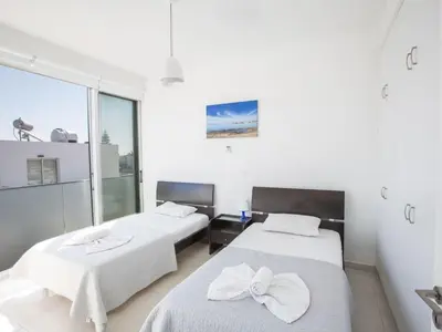 two beds in a room with a window at Holiday Home Neue Ferienvilla für 10 Personen by Interhome in Protaras