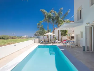 a swimming pool in the backyard of a house at Holiday Home 3-Schlafzimmer-Luxusvilla mit Pool und teilweise Meerblick by Interhome in Protaras