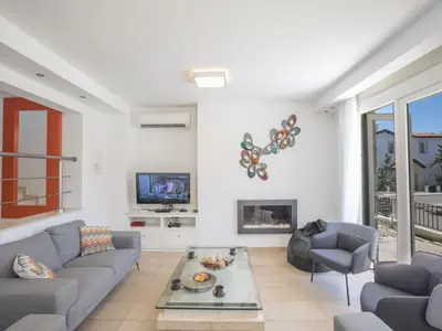 a living room with a couch and a fireplace at Holiday Home 3-Schlafzimmer-Luxusvilla mit Pool und teilweise Meerblick by Interhome in Protaras