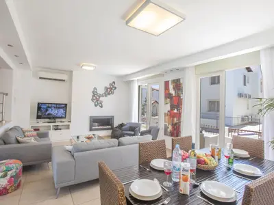 a living room with a couch and a table at Holiday Home 3-Schlafzimmer-Luxusvilla mit Pool und teilweise Meerblick by Interhome in Protaras