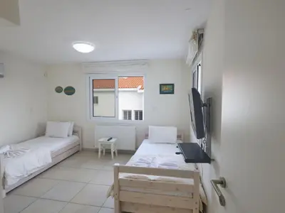 a small room with two beds and a window at Holiday Home Protaras Serifos Villa SV7 100m vom Strand entfernt by Interhome in Paralimni