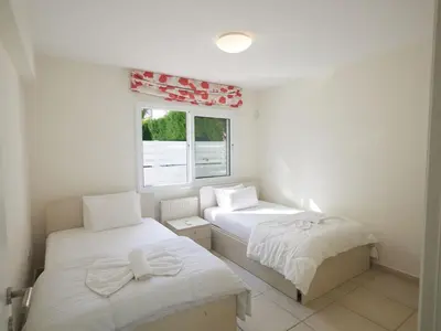 a bedroom with two beds and a window at Holiday Home Protaras Serifos Villa SV7 100m vom Strand entfernt by Interhome in Paralimni