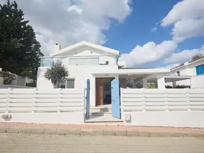 a white house with a white fence at Holiday Home Protaras Serifos Villa SV7 100m vom Strand entfernt by Interhome in Paralimni