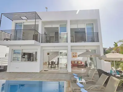 a large white house with a pool and patio at Holiday Home in Paralimni mit geräumigem Garten by Interhome in Paralimni