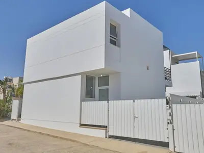 a white house with a white fence at Holiday Home in Paralimni mit geräumigem Garten by Interhome in Paralimni