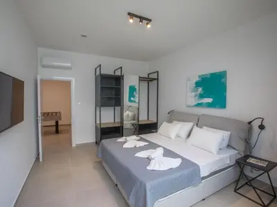 a bedroom with a bed with towels on it at Holiday Home Geräumige Villa mit großem Garten und Pool by Interhome in Protaras