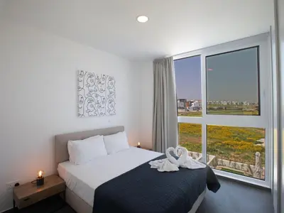 a bedroom with a bed and a large window at Holiday Home Ferienvilla Vie Bleu mit großem Pool by Interhome in Protaras