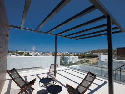 a balcony with chairs and a view of the city at Holiday Home in Protaras mit großem Garten by Interhome in Protaras