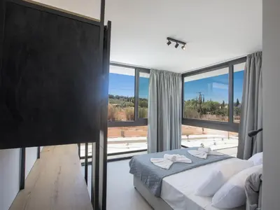 a bedroom with a bed and a large window at Holiday Home in Protaras mit großem Garten by Interhome in Protaras